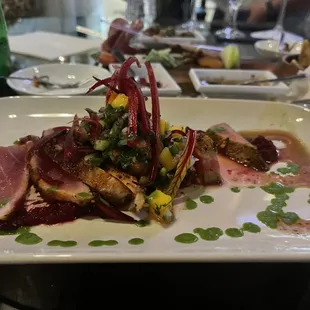 Seared all he with a mango relish on top of puréed beats with slivered beet stems it was to die for