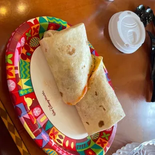 a plate with a burrito on it