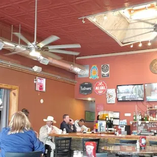 people sitting at tables in a restaurant