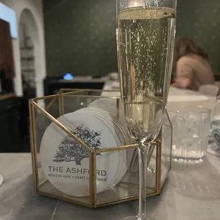 a glass of champagne on a table