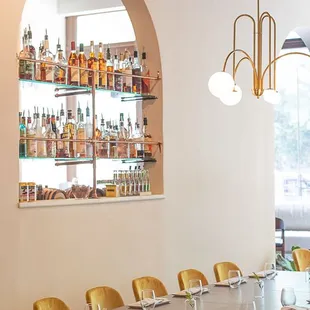 a long dining table with yellow chairs