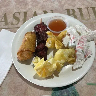 Chicken egg roll, chicken on a stick, crab rangoons, and crab salad.