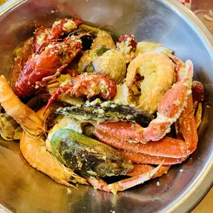 a bowl of crab legs and other seafood