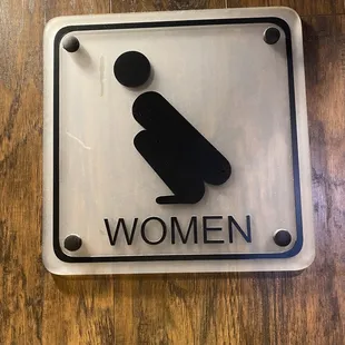 a women&apos;s restroom sign