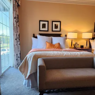 A bed and the window at Atherton Hotel.