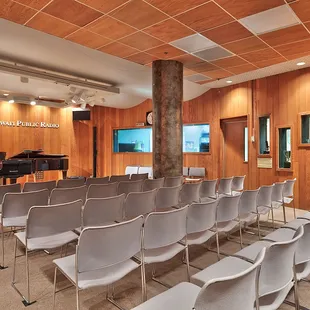 an empty room with chairs and a piano