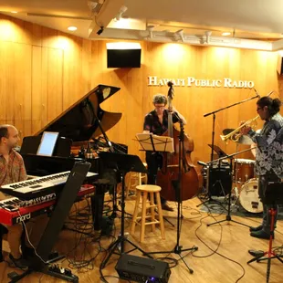 a group of musicians in a recording studio