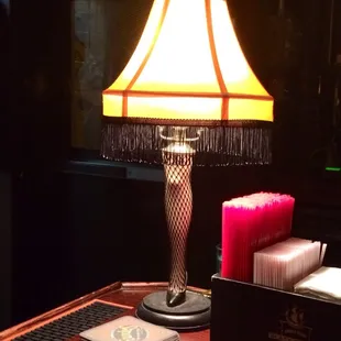 a table with a lamp and a book