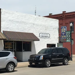 two cars parked in front of a building