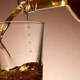 a drink being poured into a glass