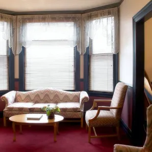 a living room with a couch and chairs