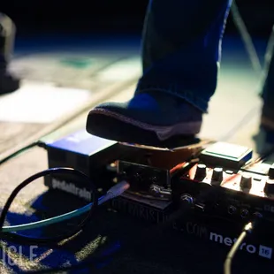 a person standing on a guitar pedal