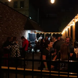 a group of people standing outside of a restaurant