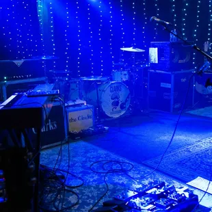 a stage with a microphone, keyboard, and other musical equipment