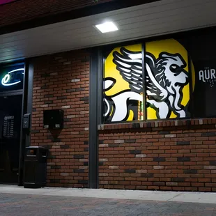 a brick building with a neon sign