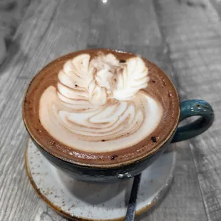 Mocha in a "bowl" with swan latte art the barista was working on