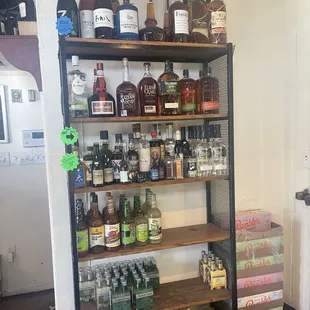 a shelf full of liquor bottles