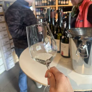 a person holding a wine glass