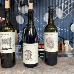 three bottles of wine on a counter