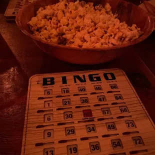 a bowl of popcorn and a bingo card
