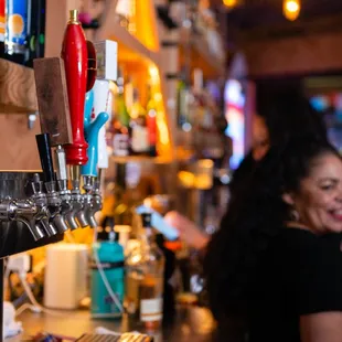 a woman at a bar smiling