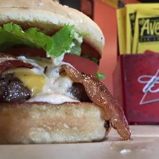 a burger with bacon and cheese