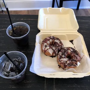 two donuts and a drink on a table