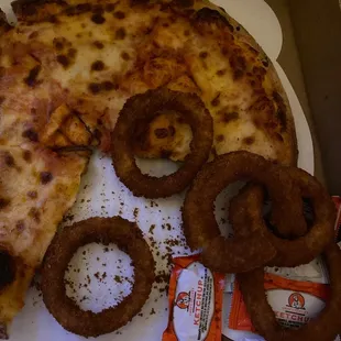 a pizza and onion rings
