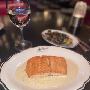 a plate of food and a glass of wine