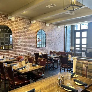 a dining room with a brick wall