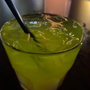 a green drink with chopsticks in it
