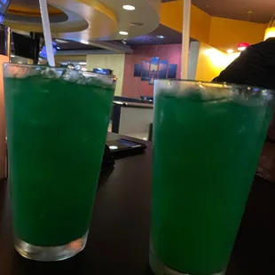 two glasses of green liquid