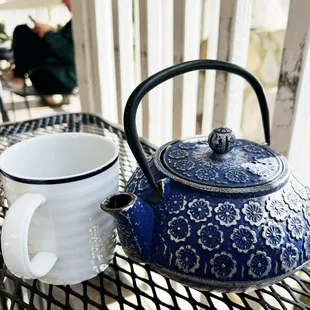 a teapot and a cup on a table