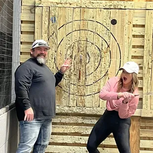 a man and a woman standing in front of a target
