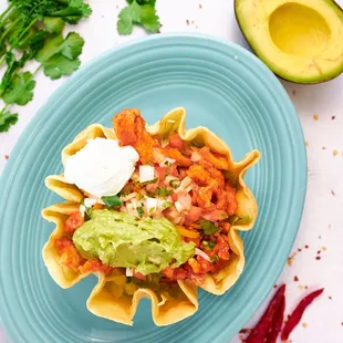 a plate of nachos with guacamole