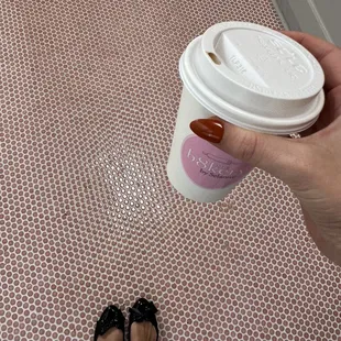 a person holding a cup of coffee