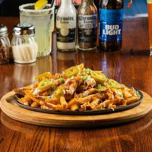 a plate of fries on a wooden table