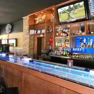 a bar with several televisions on the wall