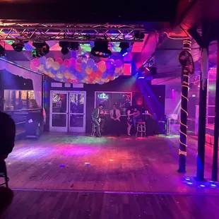 a stage with balloons and lights