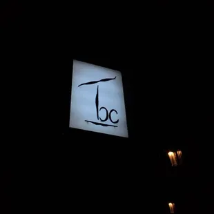 a large illuminated sign in the dark