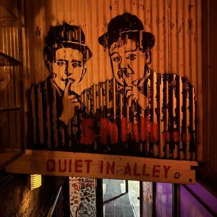 a mural of two men smoking