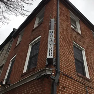 a brick building with a sign on it