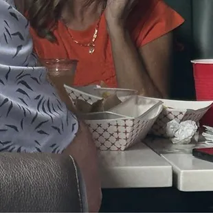 Paper boats for food. Red solo cups for drinks.