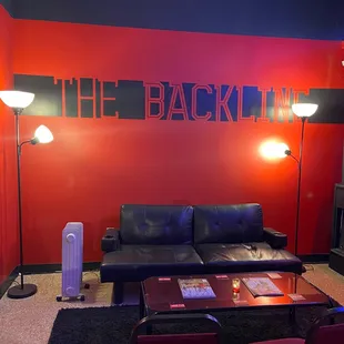 a black couch and red walls