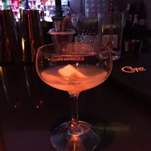 a glass of alcohol on a bar