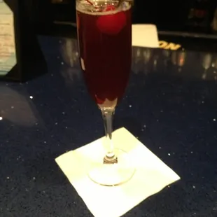 Jackie&apos;s Juice. Liefman&apos;s  Cuvée Brut, Pama liqueur &amp; fresca. Cherry garnish.