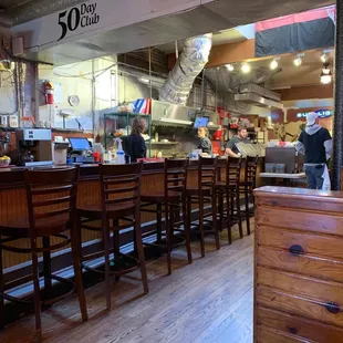 The kitchen starts at the end of the bar