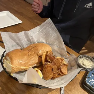 a sandwich and chips in a basket