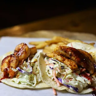 two fish tacos with coleslaw and fries