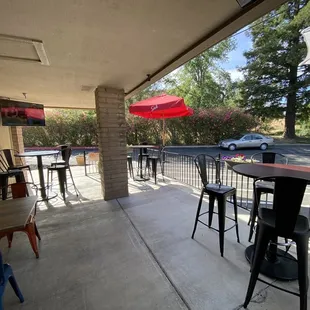 a patio with tables and chairs